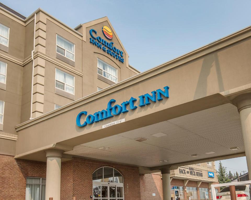 
a large building with a sign on the side of it at Comfort Inn & Suites South in Calgary
