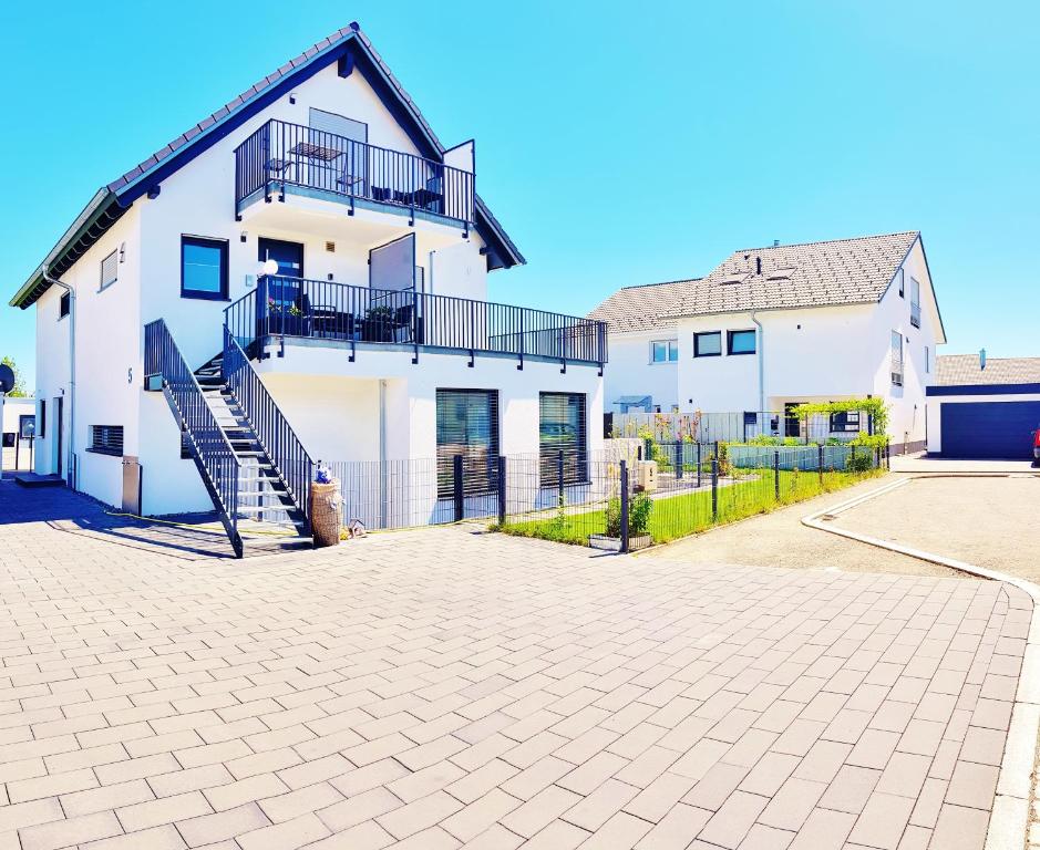 a large white house with stairs on it at Casa Muro in Friedrichshafen