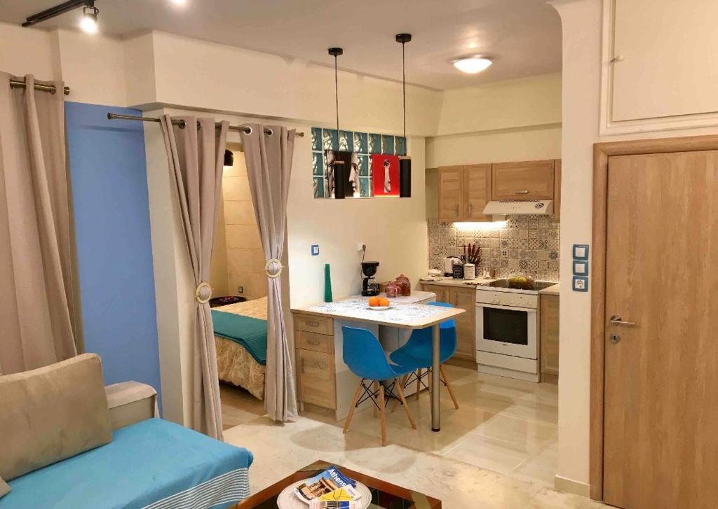 a small kitchen with a table in a room at Piraeus Blue Grand Suite di Giorgio 10 mins from the port. in Piraeus