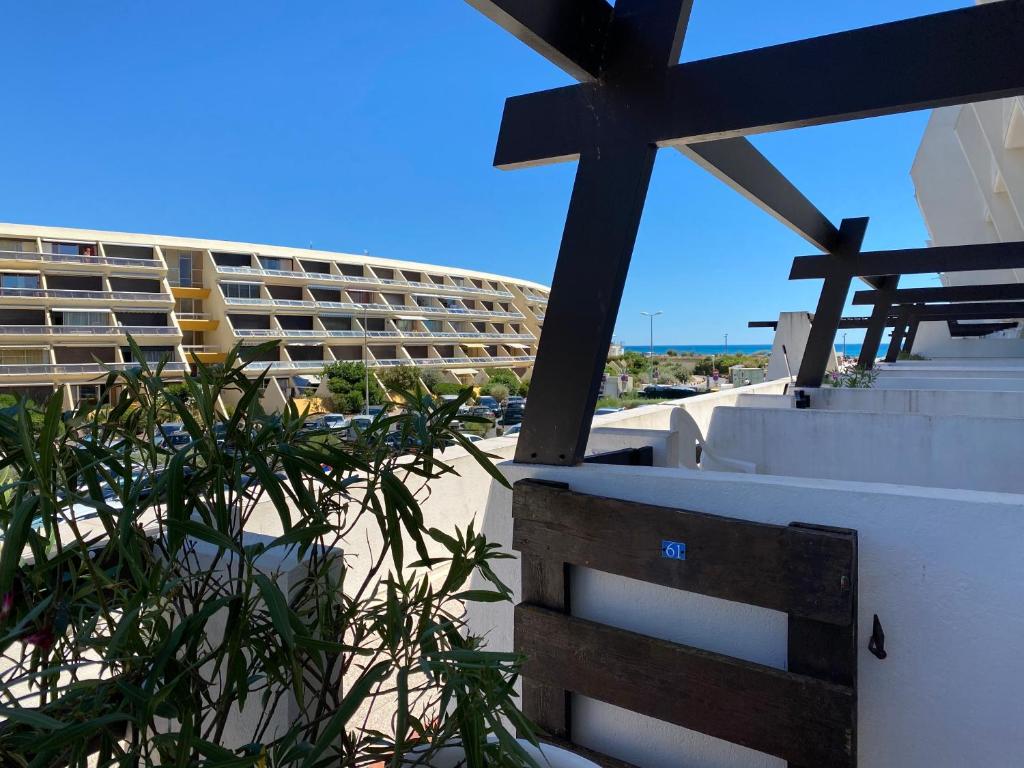 Una vista de un edificio desde la playa con una cruz. en Le Boudha Love, en Cap d'Agde