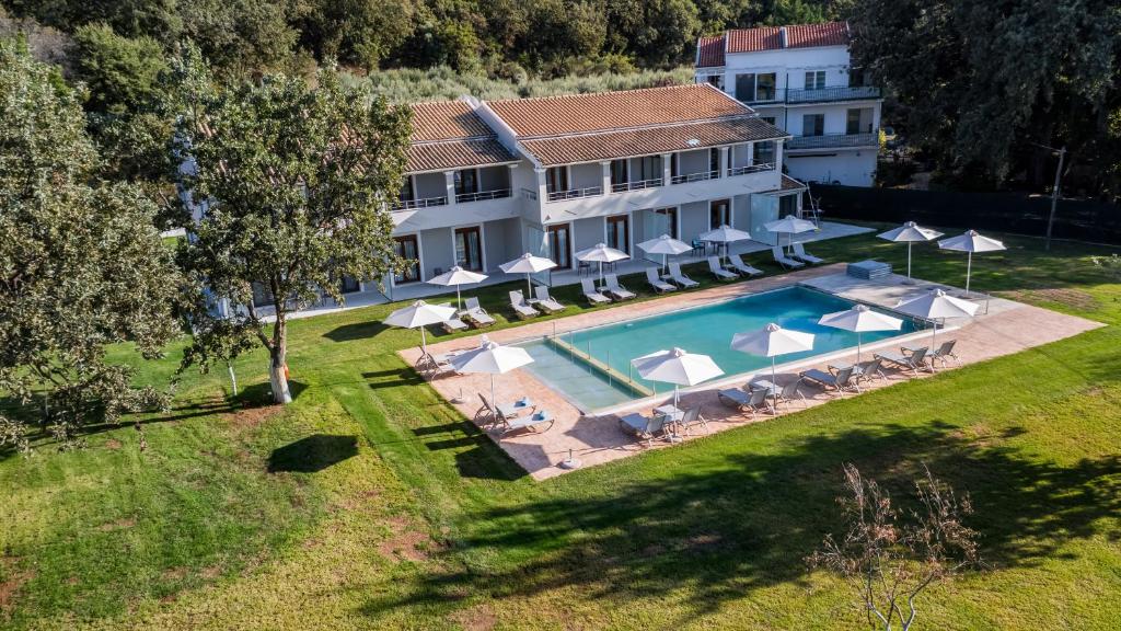 an aerial view of a house with a swimming pool at Karavos Apartments Almyros in Almiros Beach