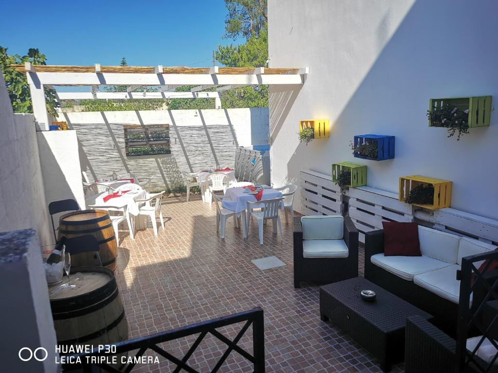 a patio with a table and chairs and a table and chairs at Magnolia in Alezio