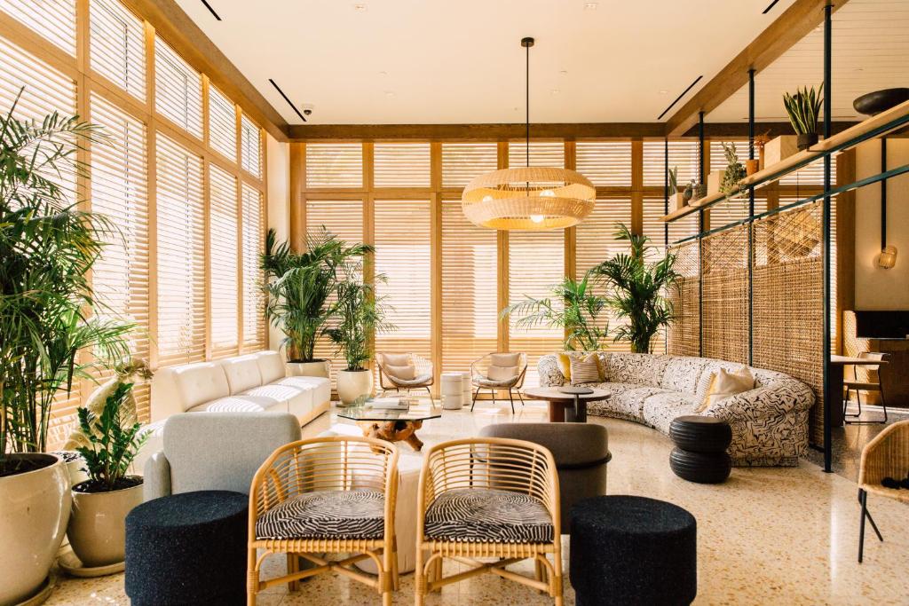 a large living room with a couch and chairs at Hotel June West LA, a Member of Design Hotels in Los Angeles