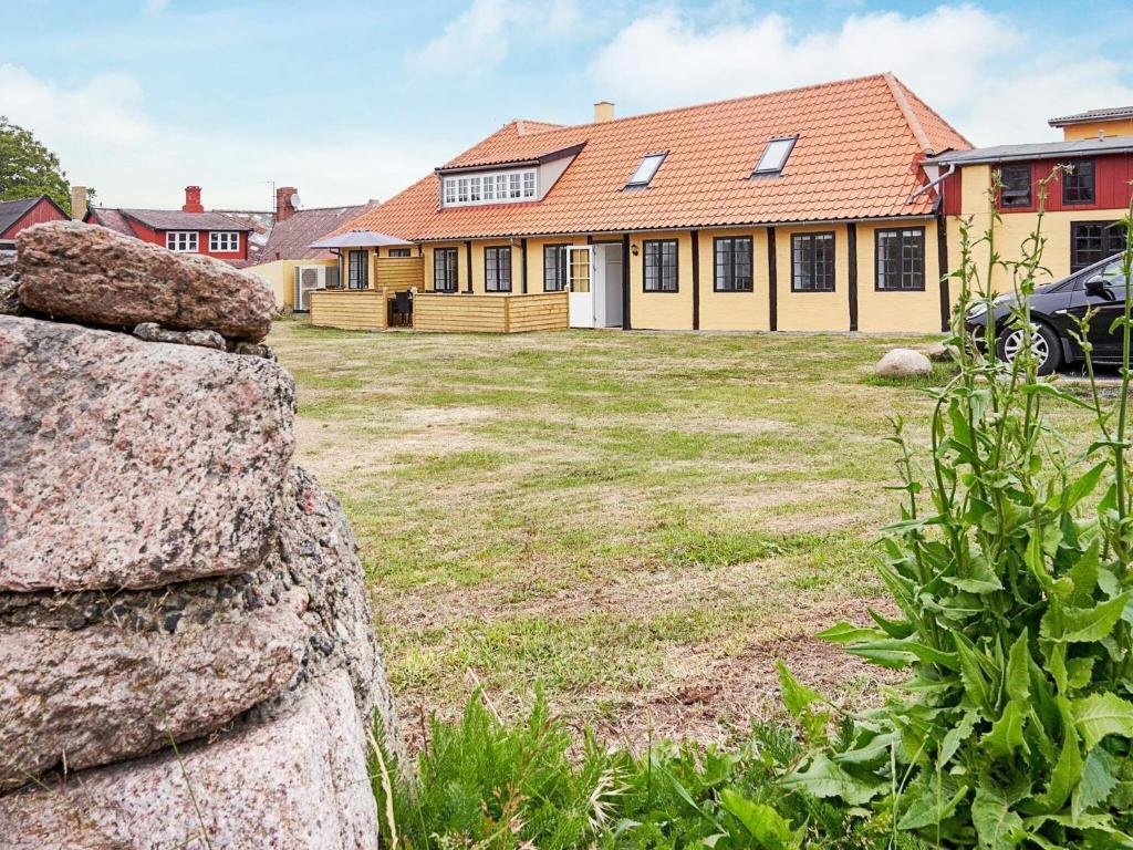 a house with a large yard in front of it at 8 person holiday home in Allinge in Allinge
