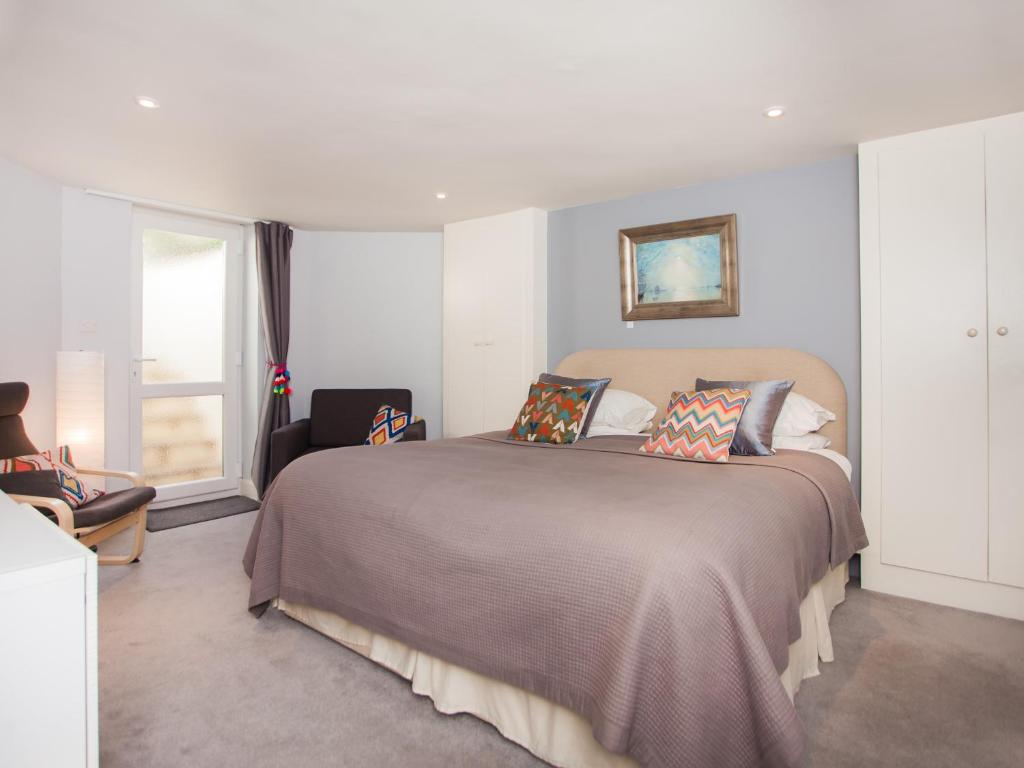 a bedroom with a large bed and a window at The Art Studio in Bath