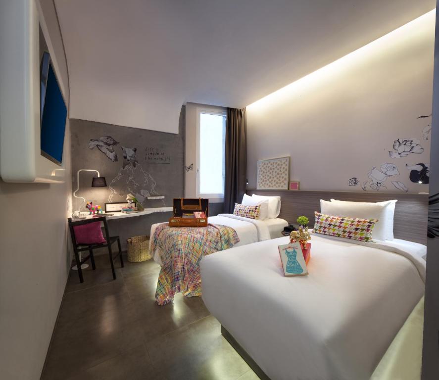 Postel nebo postele na pokoji v ubytování ARTOTEL Thamrin Jakarta