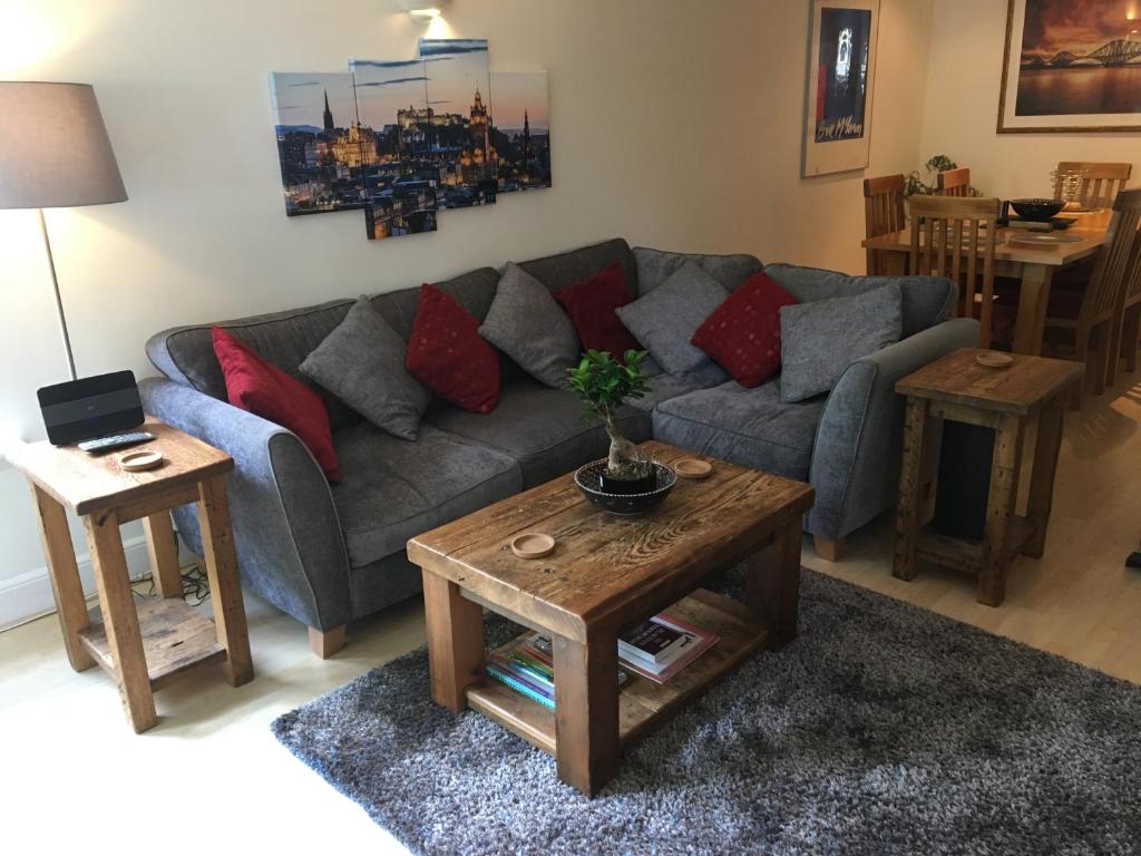 a living room with a couch and a table at Holyrood Park Apartment in Edinburgh