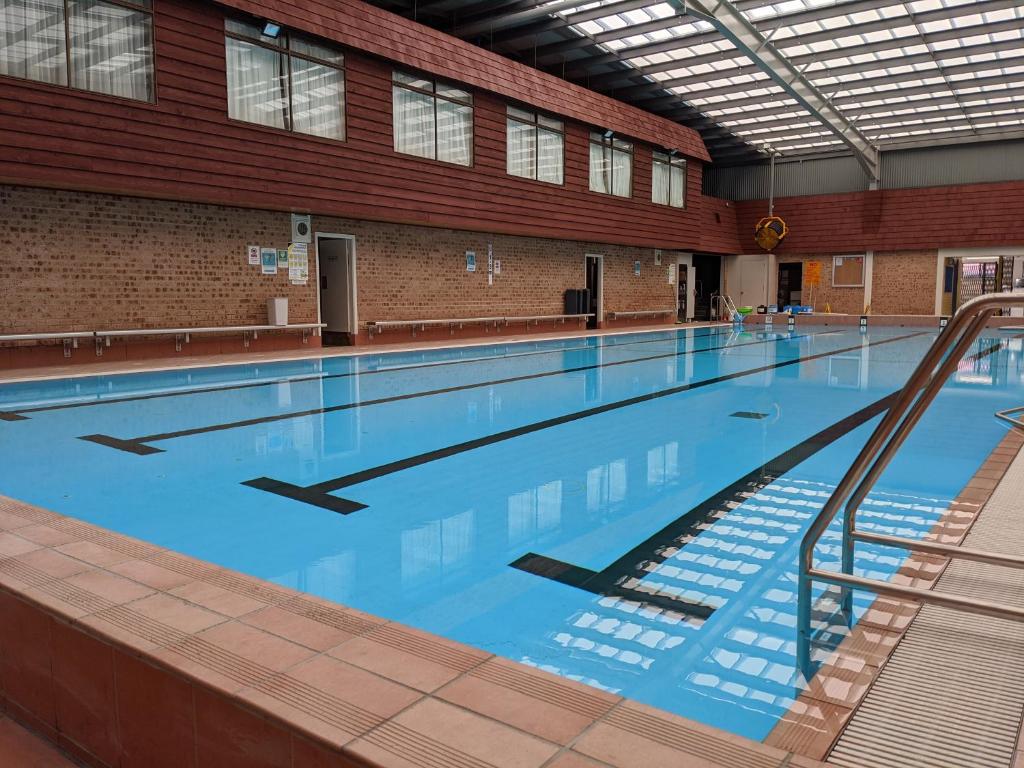 a large swimming pool in a building at Wollongong Surf Leisure Resort in Wollongong