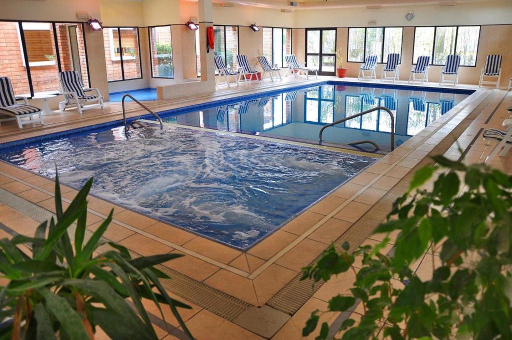 a large swimming pool in a large building at El Mirador Hotel & Spa in Colonia del Sacramento