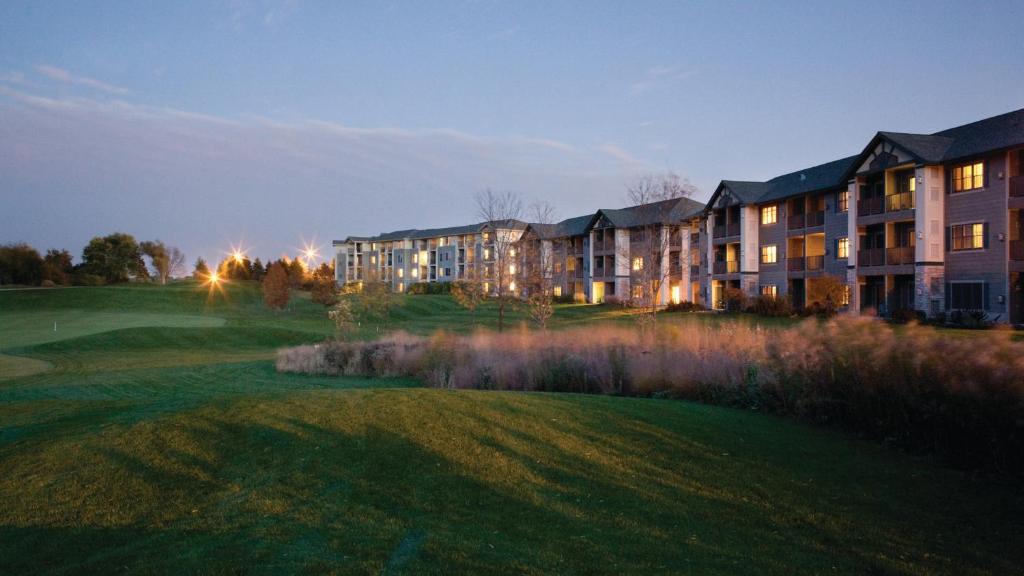 a building on a golf course at night at Holiday Inn Club Vacations at Lake Geneva Resort, an IHG Hotel in Lake Geneva