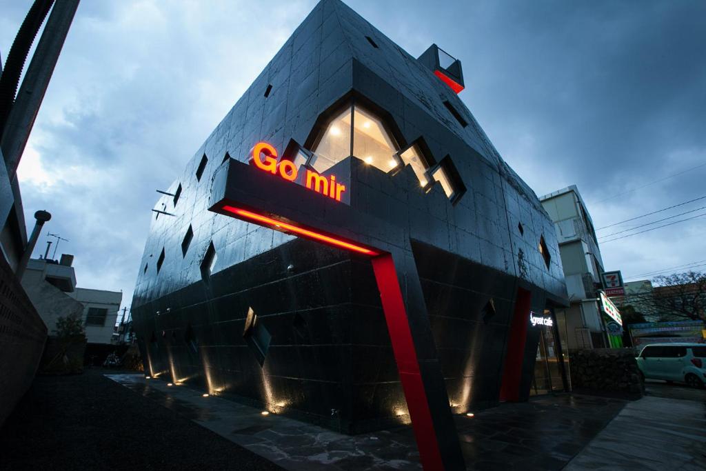 a building with a sign on the side of it at Mir Guesthouse in Jeju