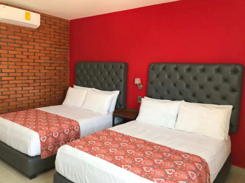 Postel nebo postele na pokoji v ubytování Hotel Jar8 Acuario enfrente al Acuario de Veracruz