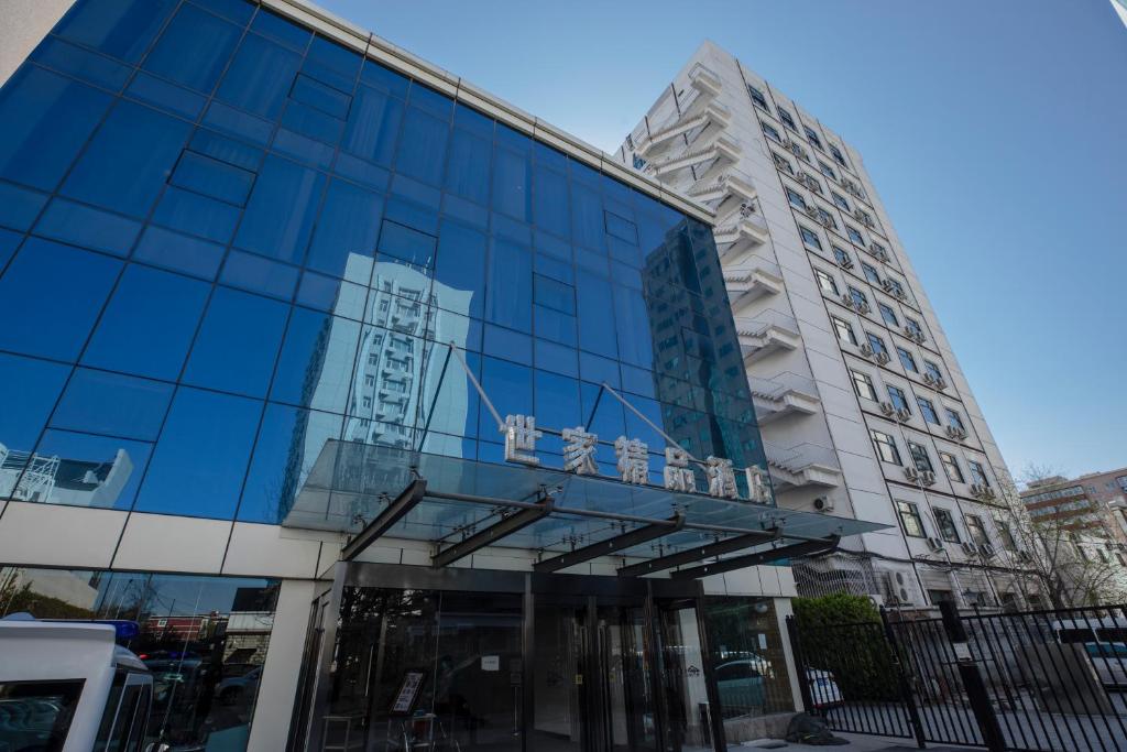 a glass building with a sign on it at Beijing Saga Hotel in Beijing