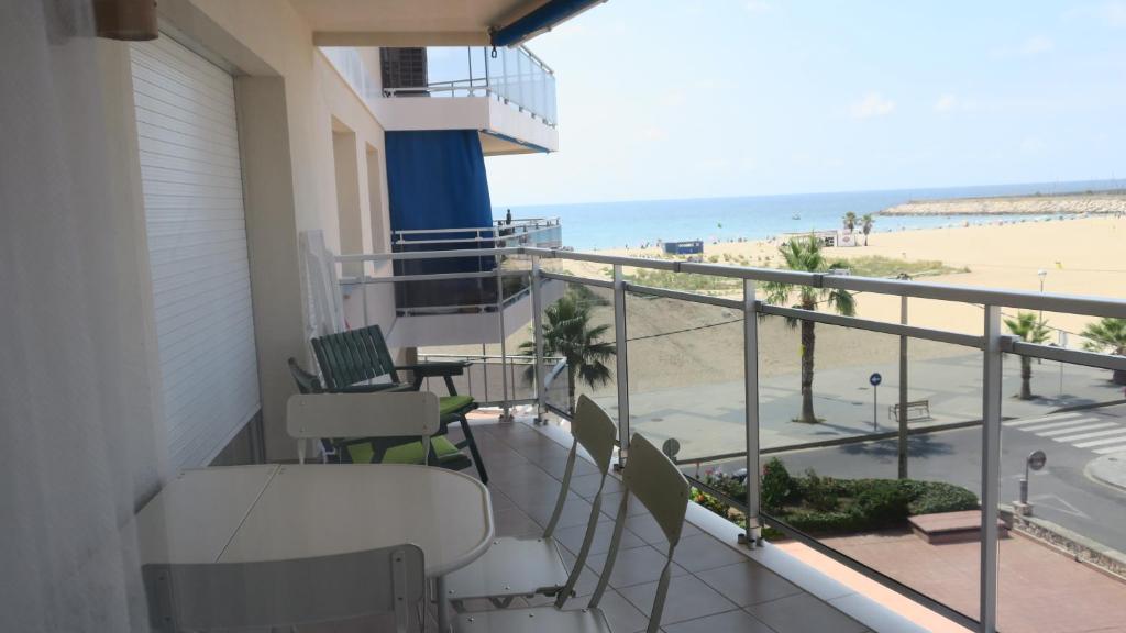 a balcony with chairs and a view of the beach at A3A Marina View in Torredembarra