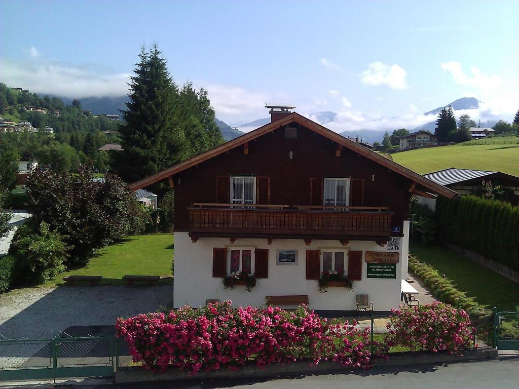 a small house with flowers in front of it at Ferienhaus Gerlinde I + II in Kaprun