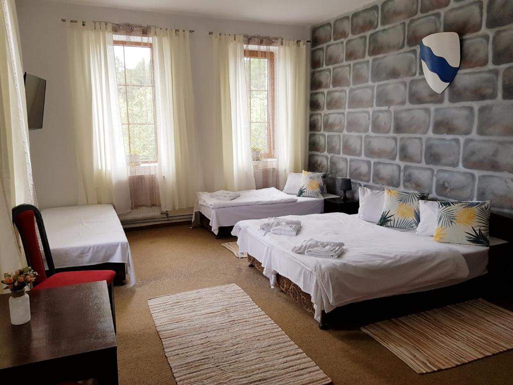 Postel nebo postele na pokoji v ubytování Hotel Camelot