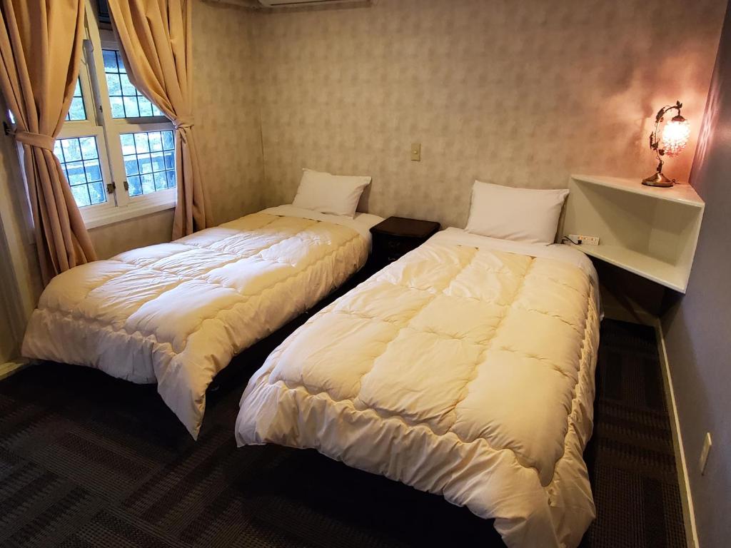 Postel nebo postele na pokoji v ubytování プチホテル葡萄屋