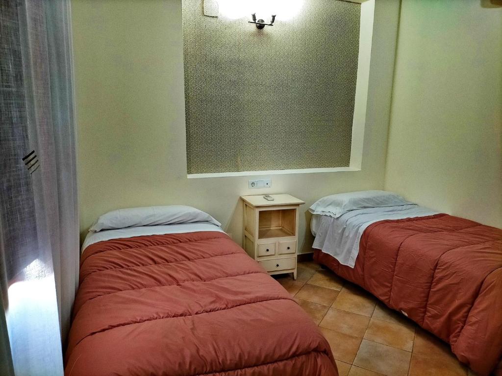 Postel nebo postele na pokoji v ubytování Abadia Suites