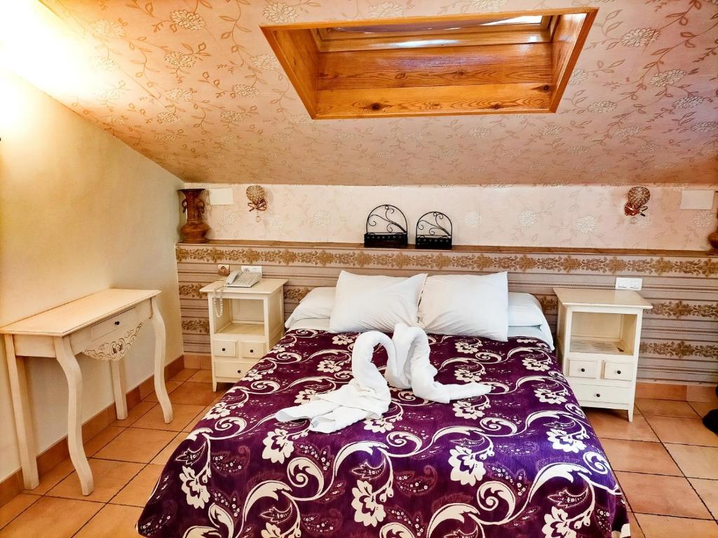 Cama o camas de una habitación en Abadía Hotel