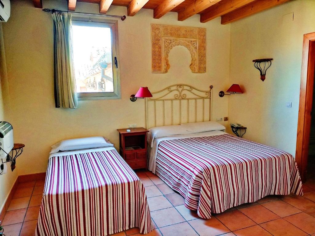 Cama o camas de una habitación en Abadía Hotel