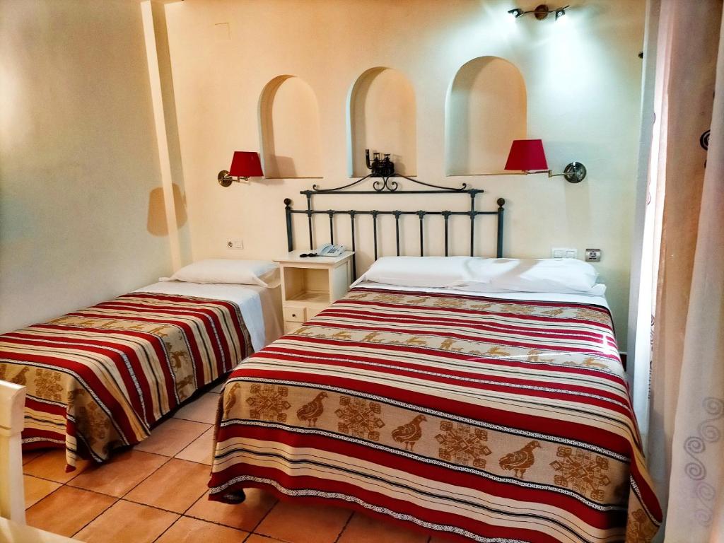 Cama o camas de una habitación en Abadía Hotel