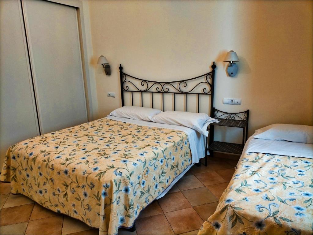 Postel nebo postele na pokoji v ubytování Abadia Suites