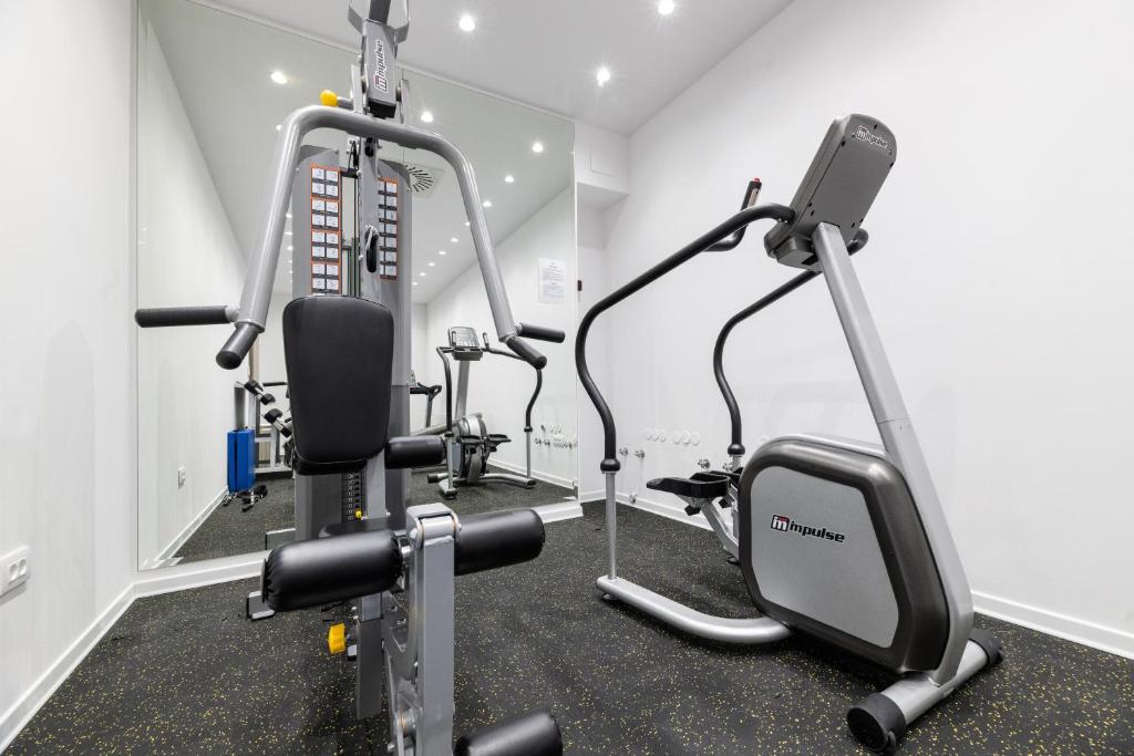 a gym with two tread machines in a room at BO Hotel Palazzo in Poreč