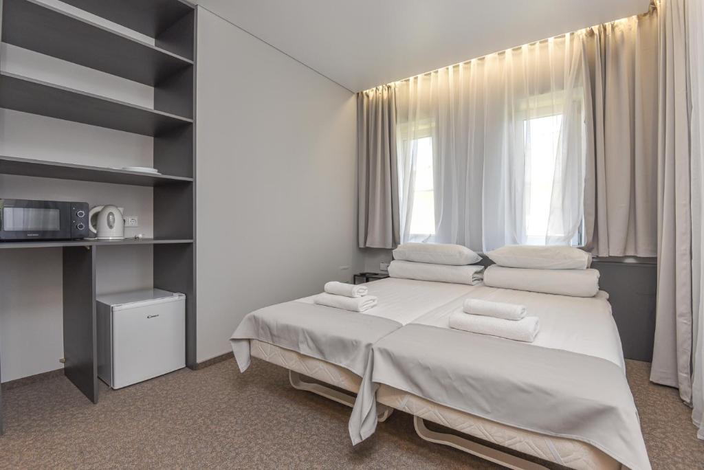 Postel nebo postele na pokoji v ubytování Palanga Centrum