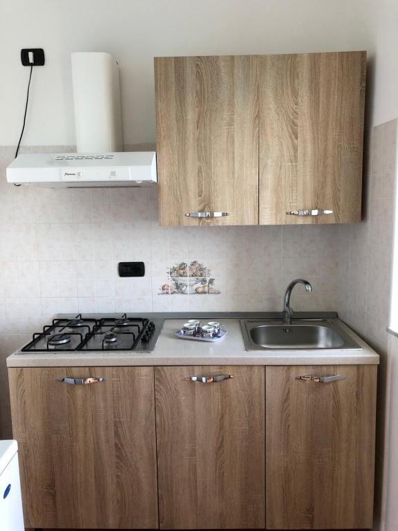 a kitchen with a sink and a stove at La Casa Sulla Scogliera in Cefalù