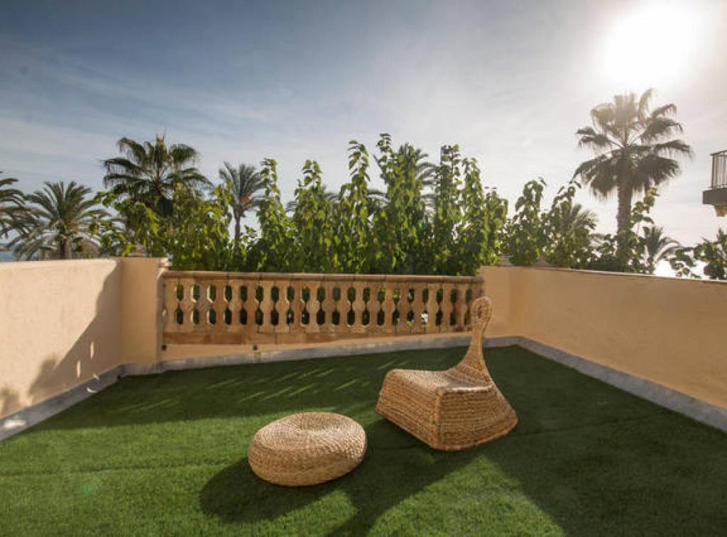 2 sillas de paja sentadas en el césped del balcón en Salou 2 · House2 garden in front of the beach - Ferrari Land, en Salou