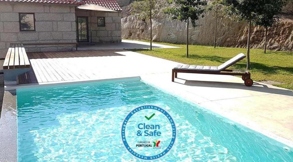 a swimming pool with a sign for clean and safe at Casa da Prelada in Amarante