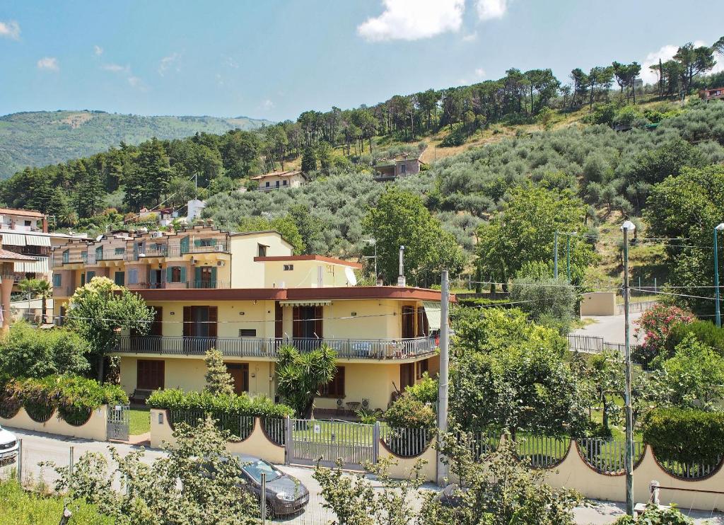 a large yellow building with a hill in the background at Villa Palmira in Quadrelle