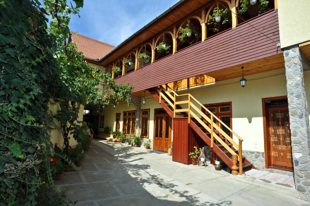 a building with a staircase on the side of it at Pensiunea Muntean in Sibiel