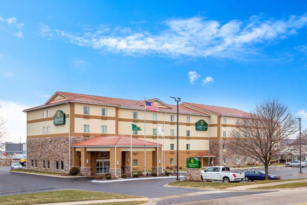 un hotel con coches estacionados en un estacionamiento en La Quinta by Wyndham Rockford, en Rockford