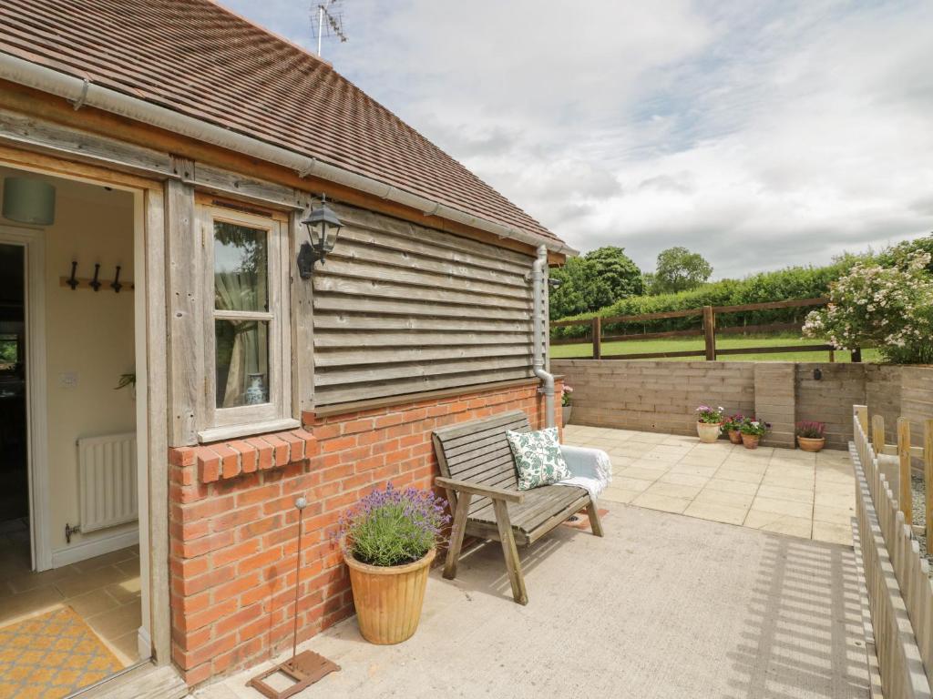 a patio of a house with a bench at Holmer Farm in Leominster