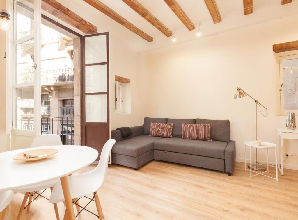 a living room with a couch and a table at Alsina · Historical center - Barrio Gótico district in Barcelona