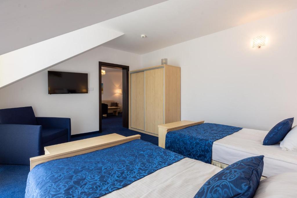 Postel nebo postele na pokoji v ubytování Hotel Jan