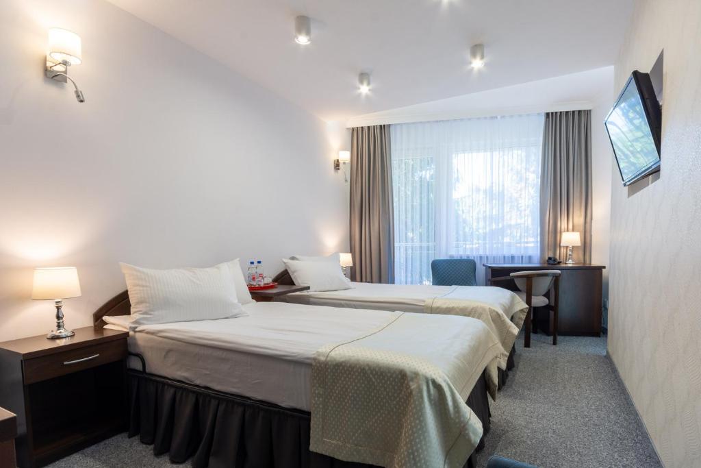 Postel nebo postele na pokoji v ubytování Hotel Jan
