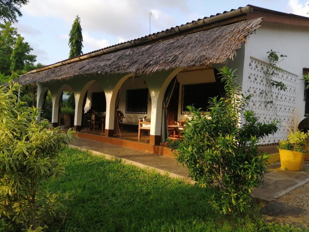 una casa con techo de paja en Sunset Villa Eco Friendly House, en Kilifi