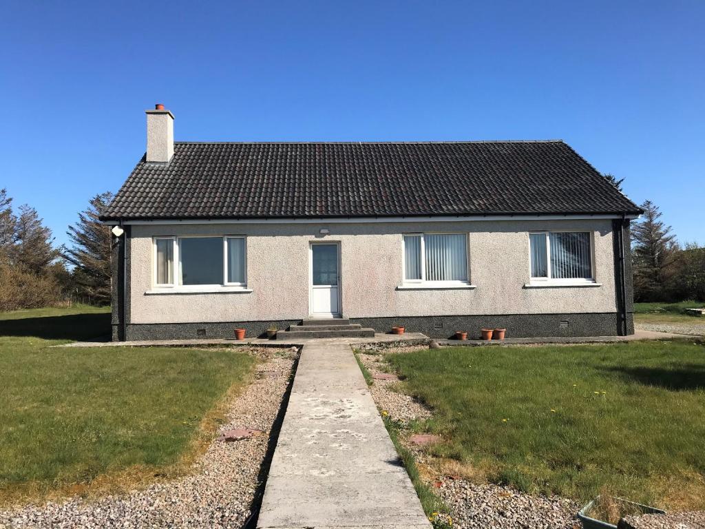 a house with a pathway in front of it at Druimard, Lower Barvas, Isle of Lewis in Barvas
