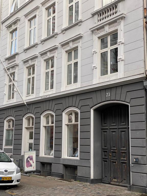 a building with a door and a car parked in front of it at PSG 23 - Short Stay Apartments by Living Suites in Copenhagen