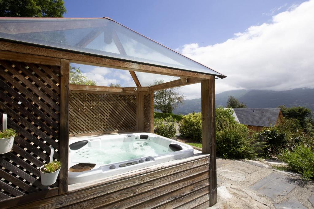 a hot tub in a gazebo with a glass roof at Les gerbes in Arras-en-Lavedan