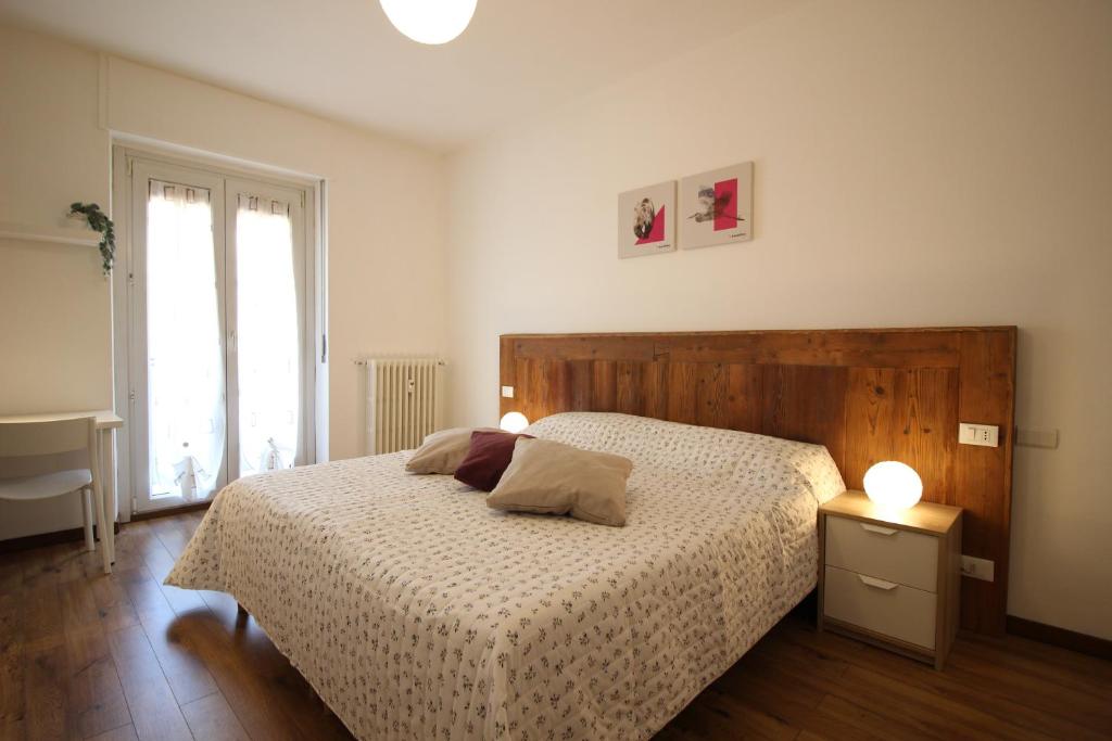 a bedroom with a bed with a wooden head board at Lovely Panoramic View Apartment - Affitti Brevi Italia in Aosta