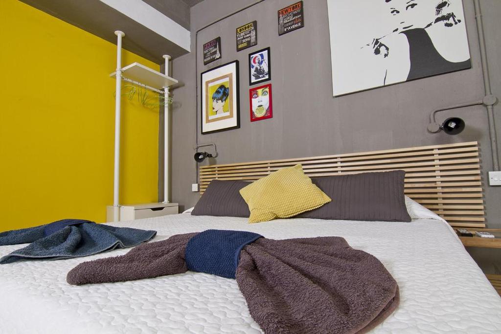a bedroom with a large bed with towels on it at Cresta Beach Studios in St. Julianʼs