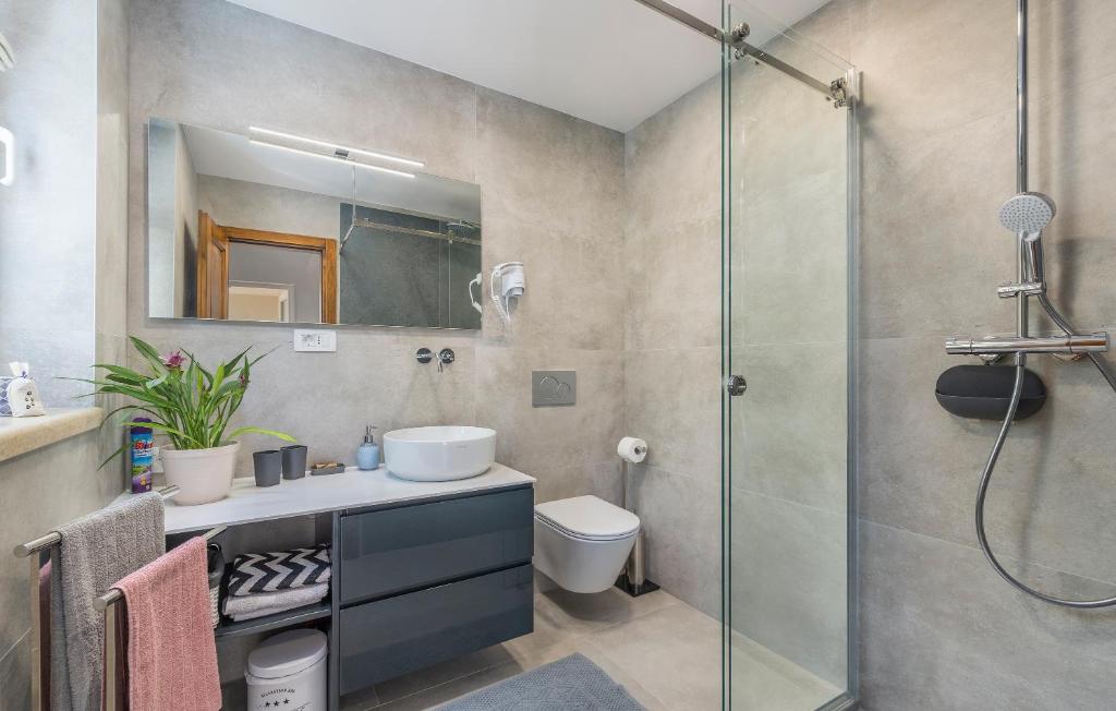 a bathroom with a sink and a glass shower at Guesthouse Casa Nova in Poreč