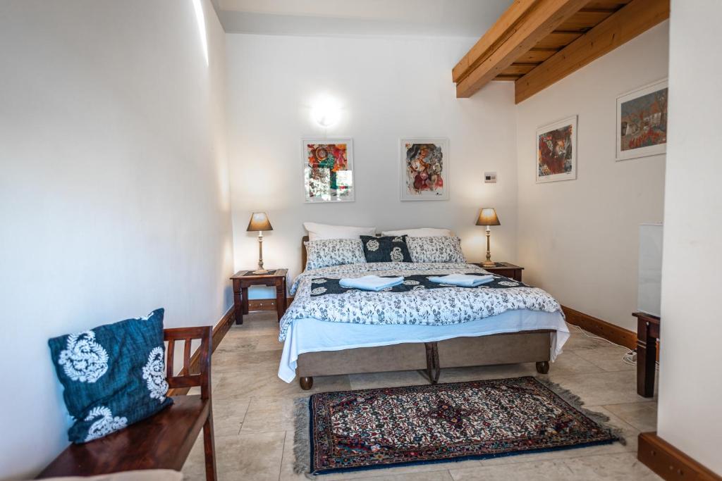 a bedroom with a bed and two chairs in it at Demetervin in Mád