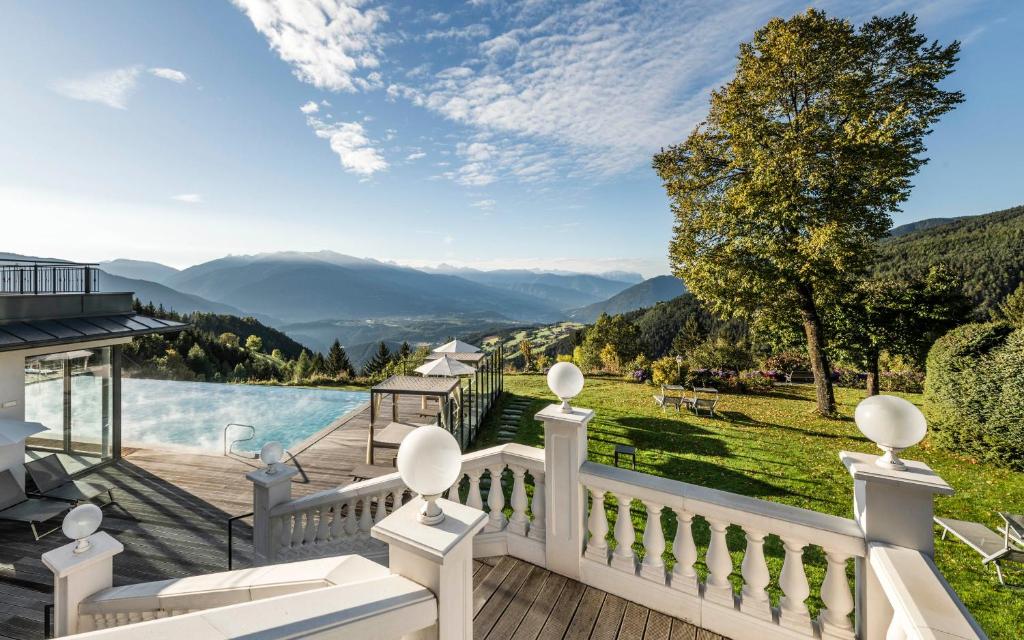 a house with a view of the mountains at Parkhotel Holzerhof in Maranza