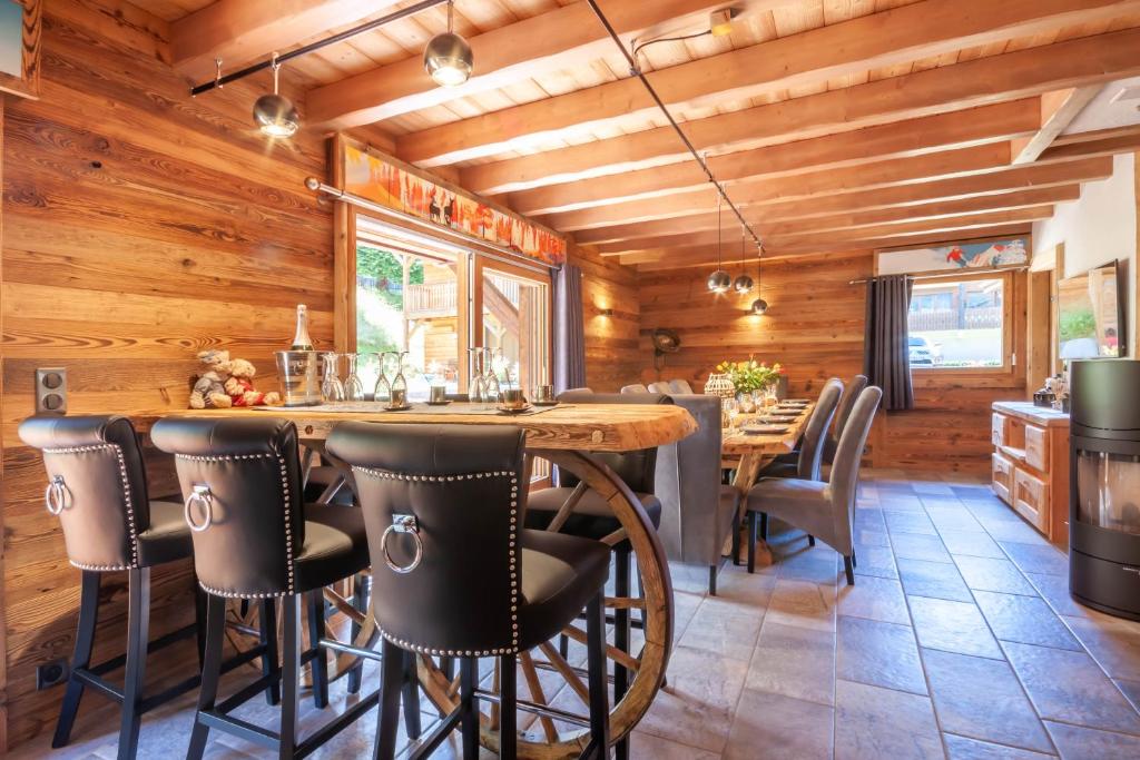 a dining room with a large wooden table and chairs at Le Nordic in Morzine