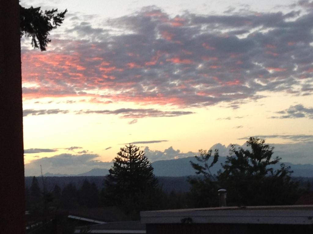 a sunset from the roof of a house at Money Pennies Bed and Breakfast in Campbell River