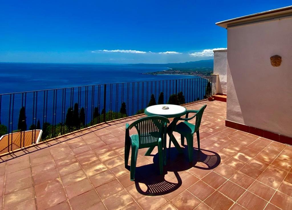タオルミーナにあるCamere Il Leoneのテーブルと椅子、海の景色を望むバルコニー